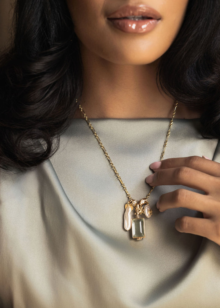 Gold rectangle locket with pearl charms, star and tiny heart.  